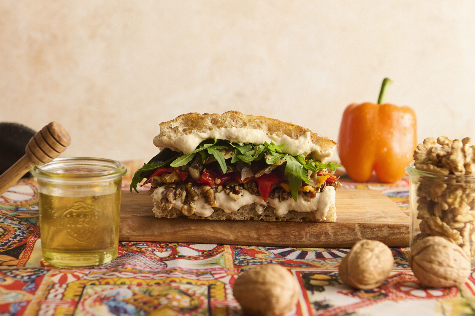 Focaccia sandwich with honey, walnuts, and roasted vegetables