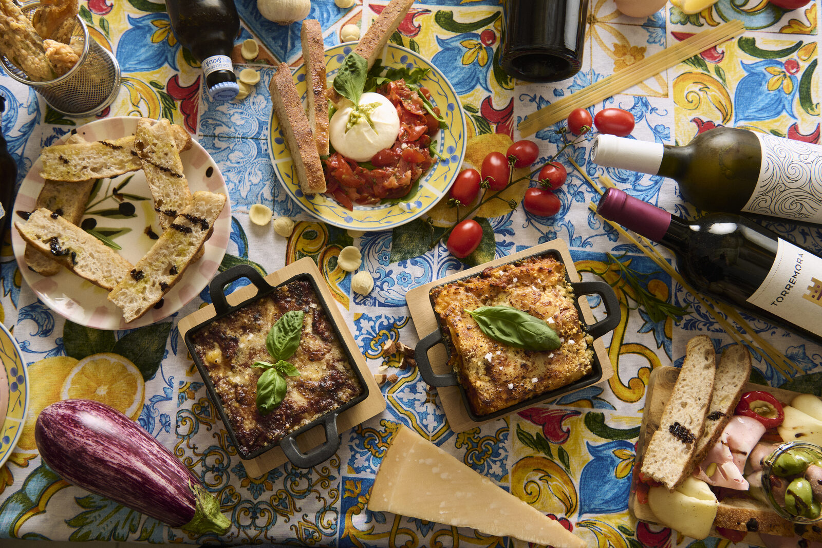 La Posata Pasta Lab spread with burrata, lasagna, and wine