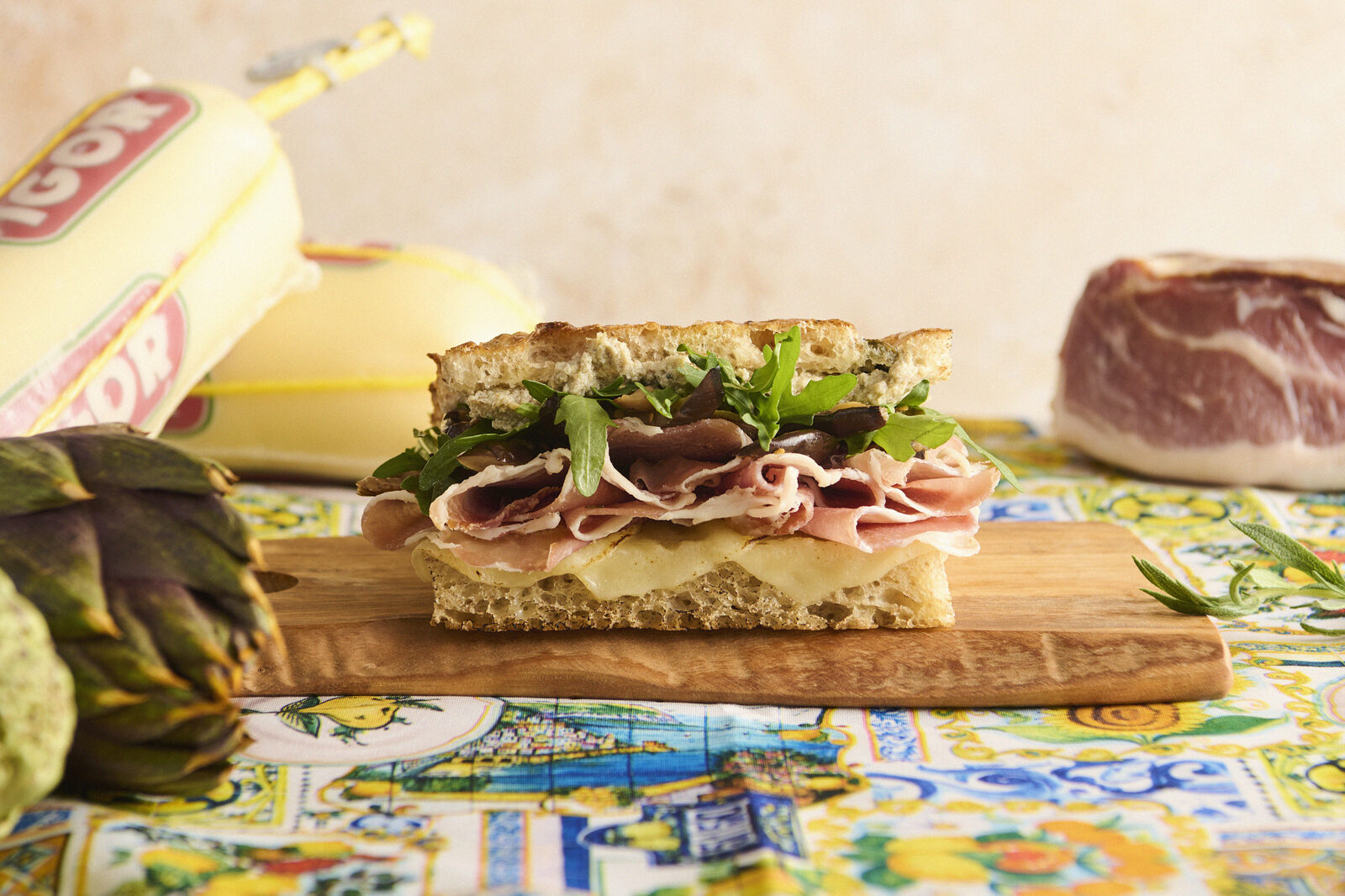 Prosciutto focaccia sandwich on cutting board